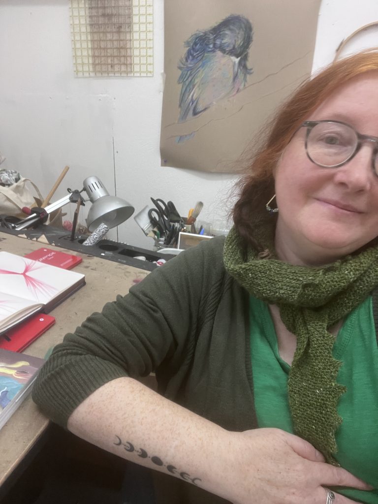 Collette Howie in studio at desk